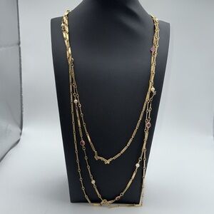 Triple strand gold tone unique necklace with pink colored “gems” / faux pearls